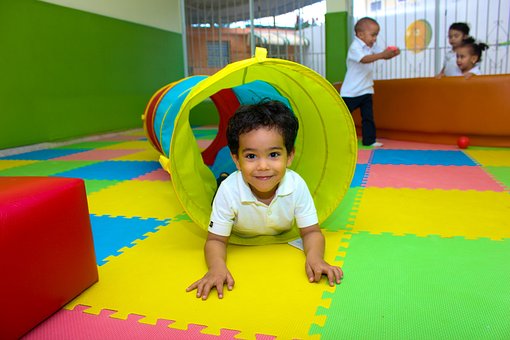 Joyful Child Exploring Colorful Play Area